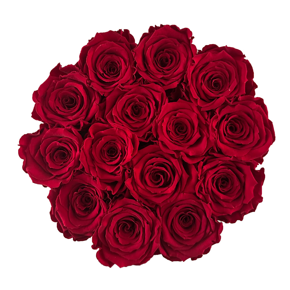 Czerwone wieczne róże w okrągłym flower boxie