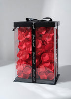 Miś z róż czerwony w opakowaniu wypełnionym płatkami róż